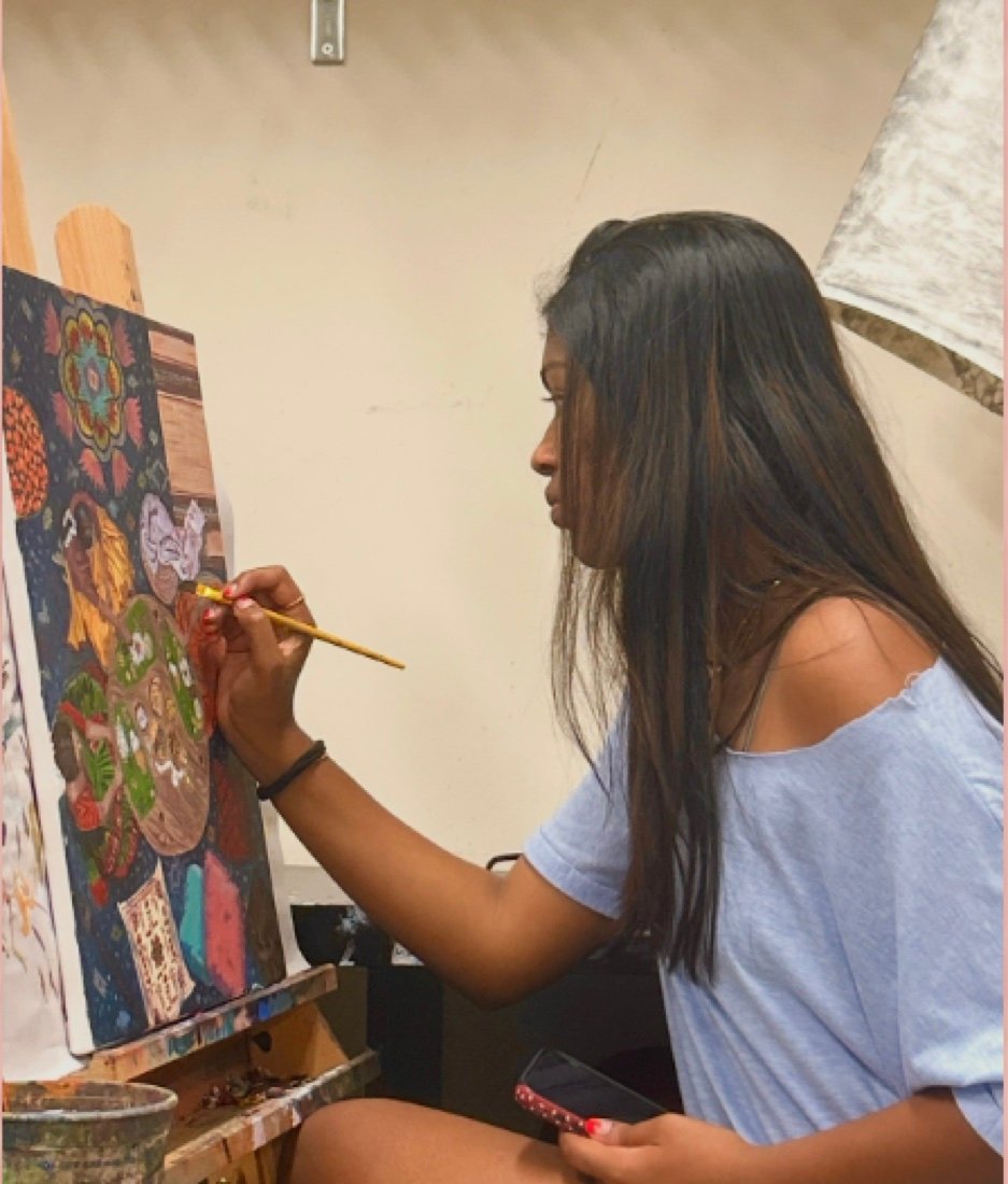 Meenal painting a detailed canvas at an easel